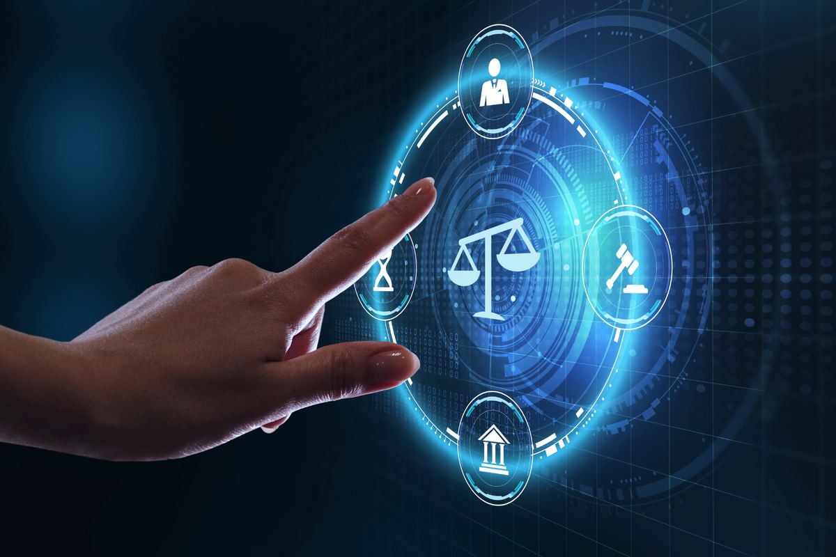 A hand interacts with a futuristic legal interface displaying icons: scales, gavel, hourglass, and building, on a blue digital background.